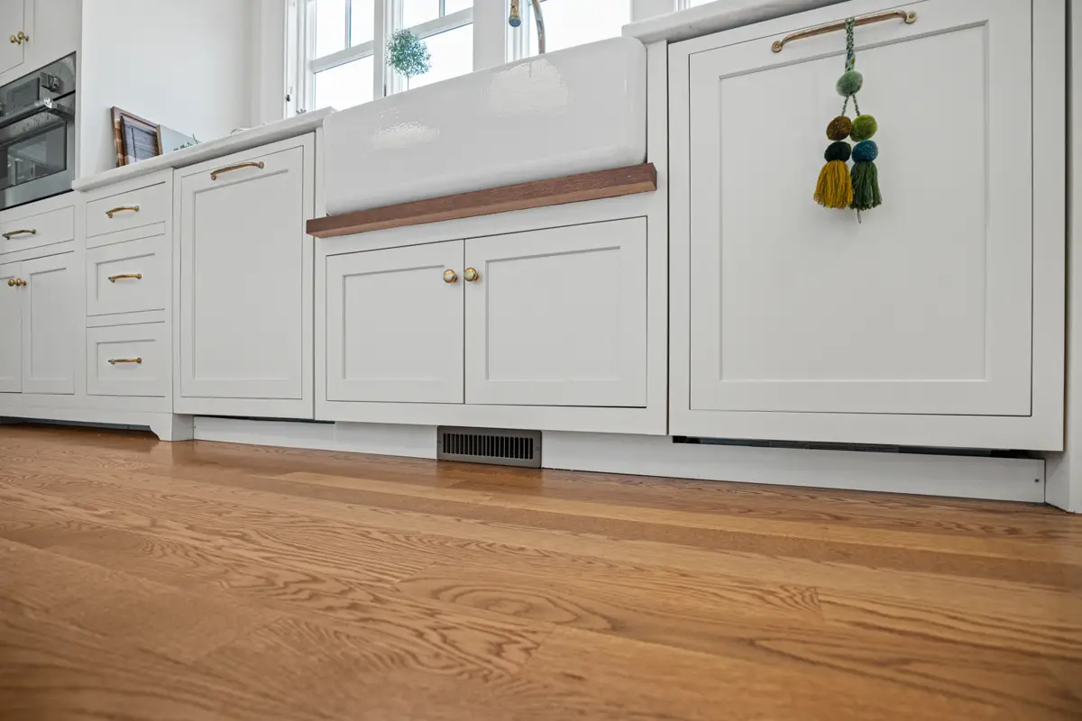 Bright white kitchen cabinets brightening a New England Ipswich kitchen
