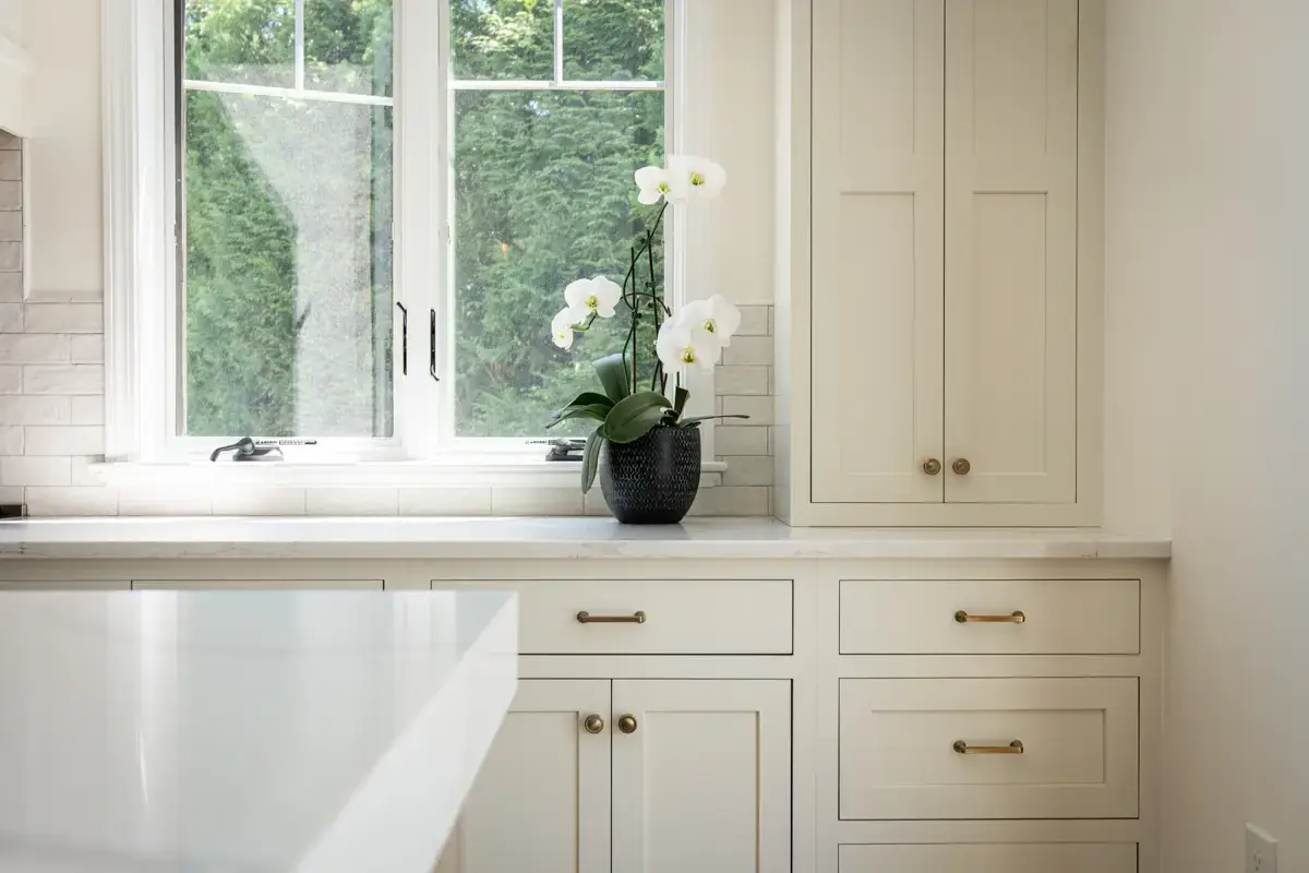 Premium white shaker kitchen cabinets with gold hardware designed by Seacoast Cabinet in Rowley MA