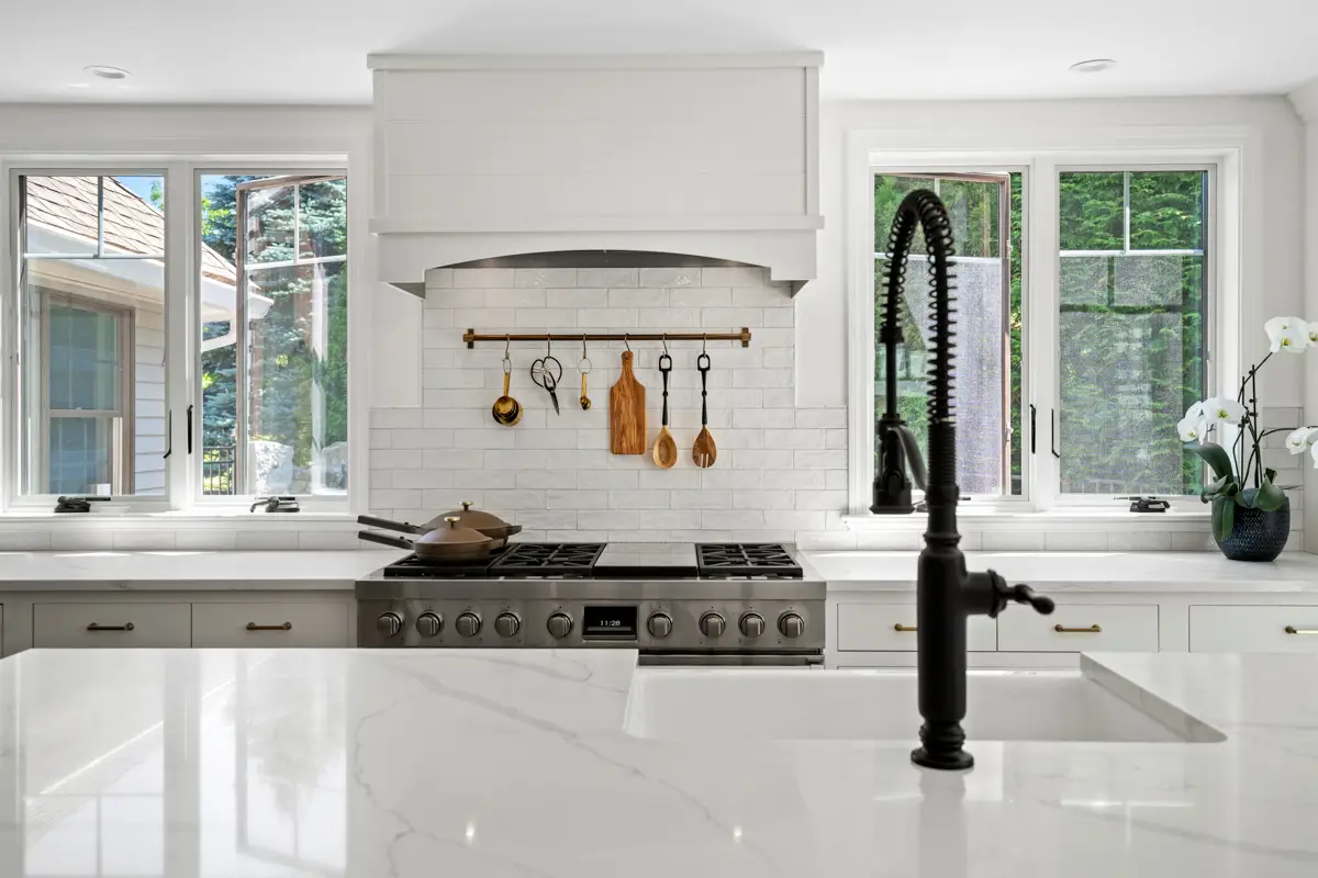 Custom kitchen with white cabinetry and modern finishes designed for an Andover MA homeowner by Seacoast Cabinet